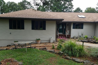 Example of a huge beige split-level house exterior design in Other