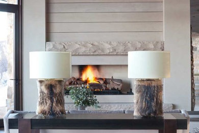 Large mountain style formal and open concept medium tone wood floor living room photo in Denver with beige walls, a standard fireplace, a stone fireplace and no tv