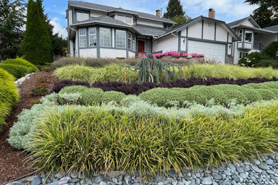Photo of a mid-sized contemporary full sun front yard landscaping in Vancouver.