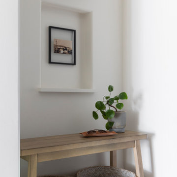 Hallway Drop Zone with Wood Console, Art Niche, and Brass Sconce