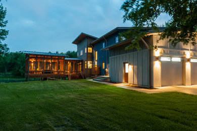 Large trendy screened-in back porch idea in Chicago with a roof extension