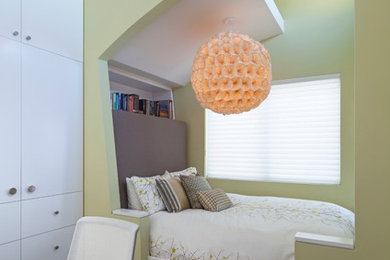 Bedroom - small modern guest dark wood floor and brown floor bedroom idea in Los Angeles with multicolored walls