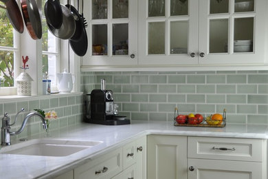 Kitchen pantry - mid-sized contemporary galley kitchen pantry idea in Seattle with light wood cabinets, granite countertops, green backsplash, ceramic backsplash and glass-front cabinets