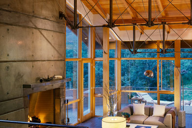 Example of a large mountain style open concept ceramic tile living room design in Other with gray walls, a standard fireplace, a concrete fireplace and no tv