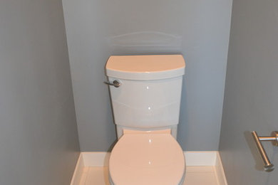 Inspiration for a mid-sized white tile and ceramic tile ceramic tile powder room remodel in Sacramento with an undermount sink, gray cabinets, quartz countertops and gray walls