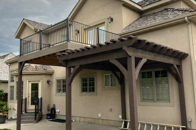 Inspiration for a mid-sized backyard metal railing deck remodel in Salt Lake City