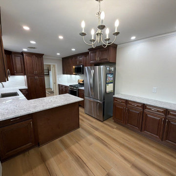USCD cabinetry accompanied granite countertops, porcelain tile backsplash and Ca