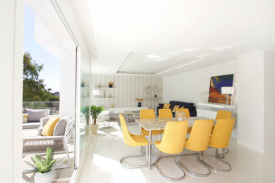 Modern dining room in Malaga with white walls.