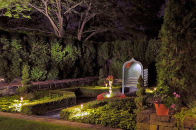 This is an example of a mid-sized traditional backyard stone formal garden in Milwaukee.