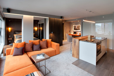 Example of a trendy open concept carpeted and gray floor living room design in Toronto with gray walls