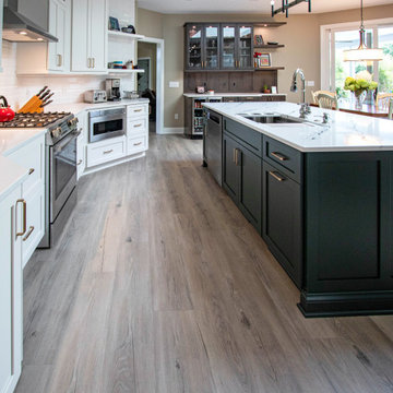 3 Finishes on Kitchen Cabinetry with Galley Workstation in Island and Wine Bar