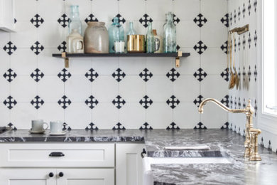 Example of an ornate l-shaped kitchen design in Portland Maine with a farmhouse sink, shaker cabinets, white cabinets, white backsplash, stainless steel appliances, no island and gray countertops