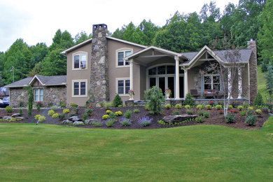Large traditional beige two-story mixed siding exterior home idea in Other with a shingle roof