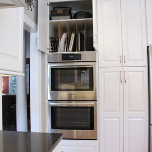 Inspiration for a mid-sized transitional u-shaped open plan kitchen in Other with an undermount sink, raised-panel cabinets, white cabinets, quartz benchtops, white splashback, subway tile splashback, stainless steel appliances, medium hardwood floors and with island.