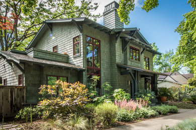Green two-story wood exterior home idea in Other