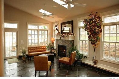 Living room - mid-sized traditional formal and enclosed medium tone wood floor living room idea in Raleigh with white walls, a standard fireplace and a brick fireplace