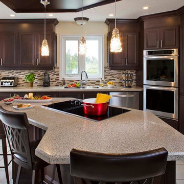 Contemporary kitchen with dark cabinets and recycled granite and glass counterto