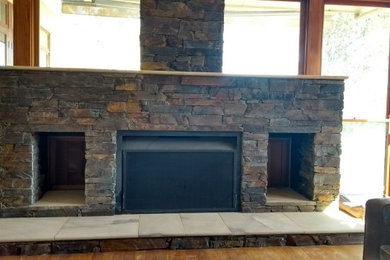 Design ideas for a country family room in Sunshine Coast with a stone fireplace surround.