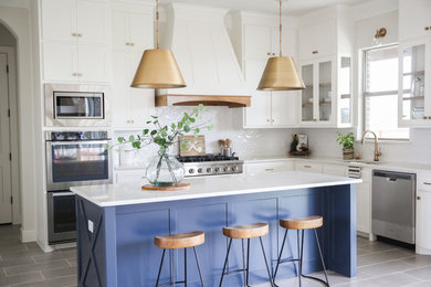 Example of a mid-sized transitional l-shaped gray floor and porcelain tile open concept kitchen design in Other with an undermount sink, shaker cabinets, white cabinets, white backsplash, stainless steel appliances, an island, white countertops, quartzite countertops and ceramic backsplash