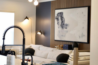 Inspiration for a large modern formal and open concept medium tone wood floor and wall paneling living room remodel in DC Metro with blue walls, a standard fireplace, a stone fireplace and a wall-mounted tv