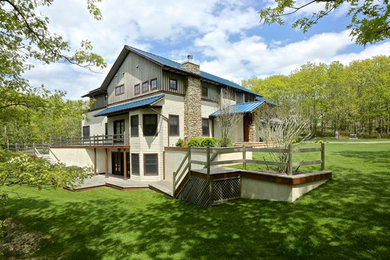Large craftsman beige two-story wood gable roof idea in New York