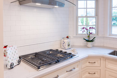 Inspiration for a mid-sized transitional u-shaped medium tone wood floor and brown floor eat-in kitchen remodel in San Francisco with an undermount sink, beaded inset cabinets, white cabinets, quartz countertops, white backsplash, subway tile backsplash, stainless steel appliances, no island and white countertops