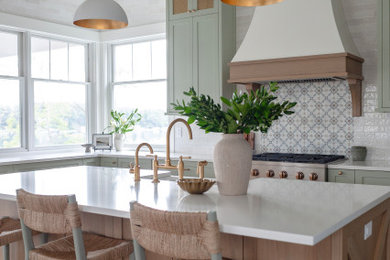 Beach style brown floor and exposed beam kitchen photo in Other with a farmhouse sink, shaker cabinets, green cabinets, quartz countertops, white backsplash, marble backsplash and white countertops