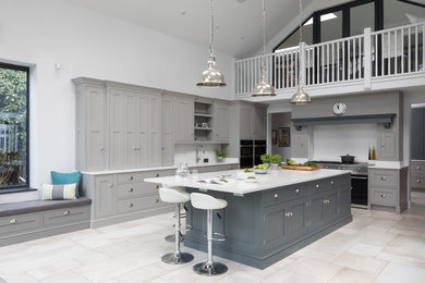 Design ideas for a large traditional u-shaped open plan kitchen in Surrey with an integrated sink, shaker cabinets, grey cabinets, quartzite benchtops, white splashback, stone slab splashback, stainless steel appliances, porcelain floors, with island, multi-coloured floor and white benchtop.