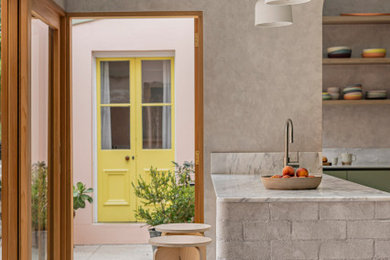 Design ideas for a contemporary kitchen pantry in Sydney with an undermount sink, green cabinets, marble benchtops, marble splashback, stainless steel appliances, concrete floors, a peninsula and grey floor.