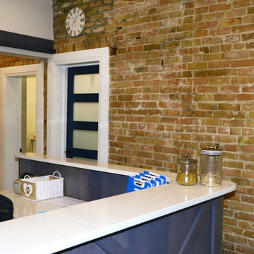 Reception After Exposed brick wall and new reception desk