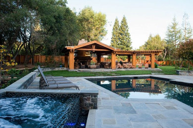 Huge trendy backyard stone and custom-shaped lap hot tub photo in San Francisco