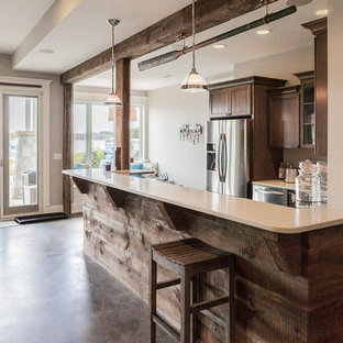 Photo of a large rustic walk-out basement in Milwaukee with grey walls, concrete flooring, no fireplace and brown floors.