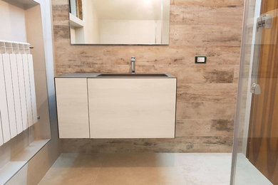 Inspiration for a small modern 3/4 bathroom in Venice with beige cabinets, a two-piece toilet, brown tile, porcelain tile, beige walls, porcelain floors, an integrated sink and beige floor.