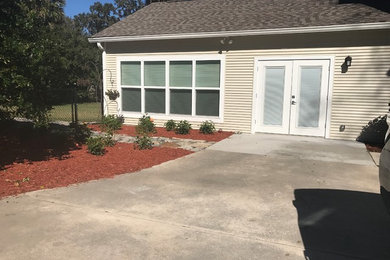 Example of a small classic yellow one-story concrete fiberboard exterior home design in Orlando with a shingle roof