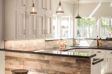 Example of a mountain style single-wall eat-in kitchen design in Houston with recessed-panel cabinets, beige cabinets and a peninsula