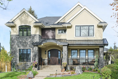 Huge elegant beige two-story stucco exterior home photo in Edmonton with a metal roof