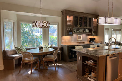 Example of a large classic galley dark wood floor and brown floor eat-in kitchen design in Atlanta with a single-bowl sink, shaker cabinets, brown cabinets, quartzite countertops, blue backsplash, mosaic tile backsplash, stainless steel appliances, an island and green countertops