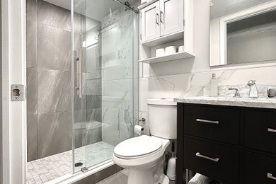 Mid-sized minimalist white tile slate floor, gray floor and single-sink bathroom photo in Philadelphia with flat-panel cabinets, black cabinets, gray walls and gray countertops