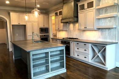 Inspiration for a mid-sized industrial l-shaped dark wood floor kitchen pantry remodel in Raleigh with an undermount sink, flat-panel cabinets, white cabinets, granite countertops, white backsplash, marble backsplash, stainless steel appliances, an island and black countertops