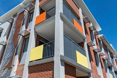 Design ideas for a contemporary three-storey apartment exterior in Perth.