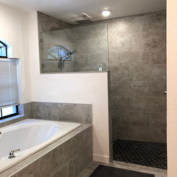 Custom zero entry, ceiling mounted shower head and linear drain bathroom