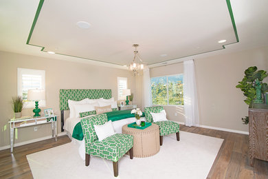 Example of an island style master light wood floor bedroom design in Los Angeles with beige walls