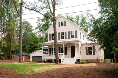 Mid-sized traditional two-storey beige exterior in Raleigh with concrete fiberboard siding and a gable roof.