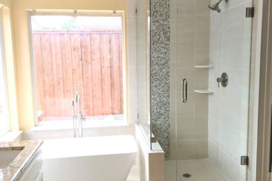 Example of a transitional beige tile and porcelain tile porcelain tile and beige floor bathroom design in Dallas with white cabinets, a two-piece toilet, an undermount sink, granite countertops and a hinged shower door