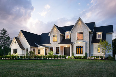 Inspiration for a large french country two-story stone house exterior remodel in New York