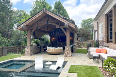 Design ideas for a country backyard patio in Charlotte with natural stone pavers.