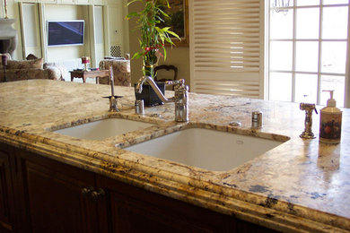 Open concept kitchen - open concept kitchen idea in Other with a double-bowl sink, recessed-panel cabinets, medium tone wood cabinets, granite countertops, beige backsplash, stainless steel appliances and an island