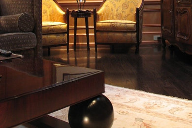 Example of a large trendy open concept dark wood floor and brown floor family room library design in Montreal with brown walls, no fireplace and a media wall