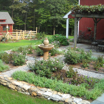 A garden fountain is the focal point of the backyard oasis
