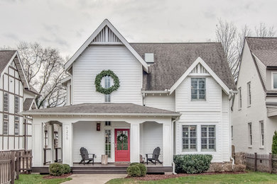 Cottage white two-story exterior home idea in Nashville with a shingle roof